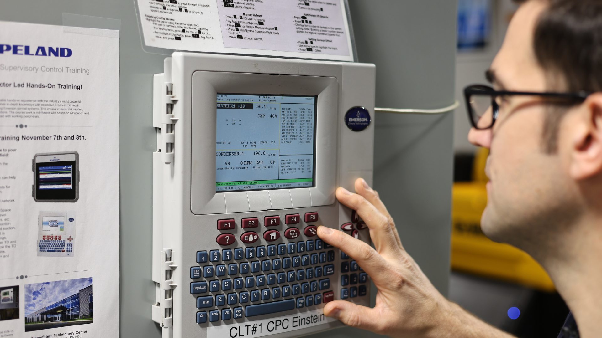 Technician reading system conditions for CO2 troubleshooting in refrigeration