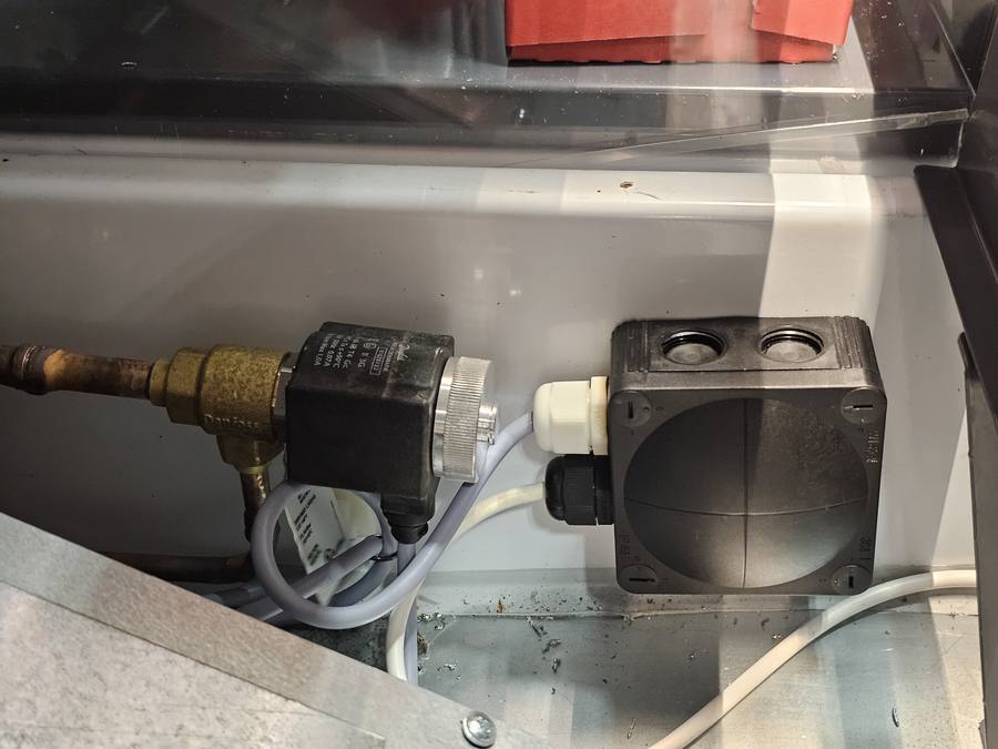 Technician installing refrigeration component in a system